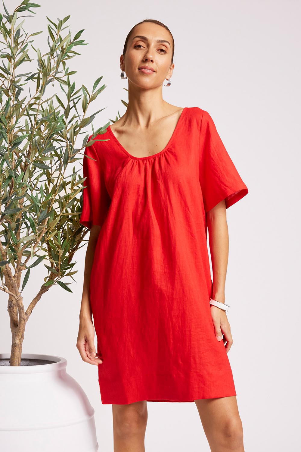 Model Genericm wearing size sample of the Cove Dress – Aperol in colour Aperol, in a cropped view