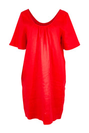 Product shot of the Cove Dress – Aperol in colour Aperol, from the front