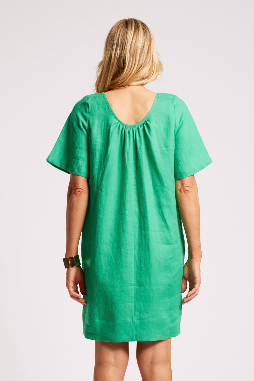 Model Genericm wearing size sample of the Cove Dress – Jade in colour Jade, from the back