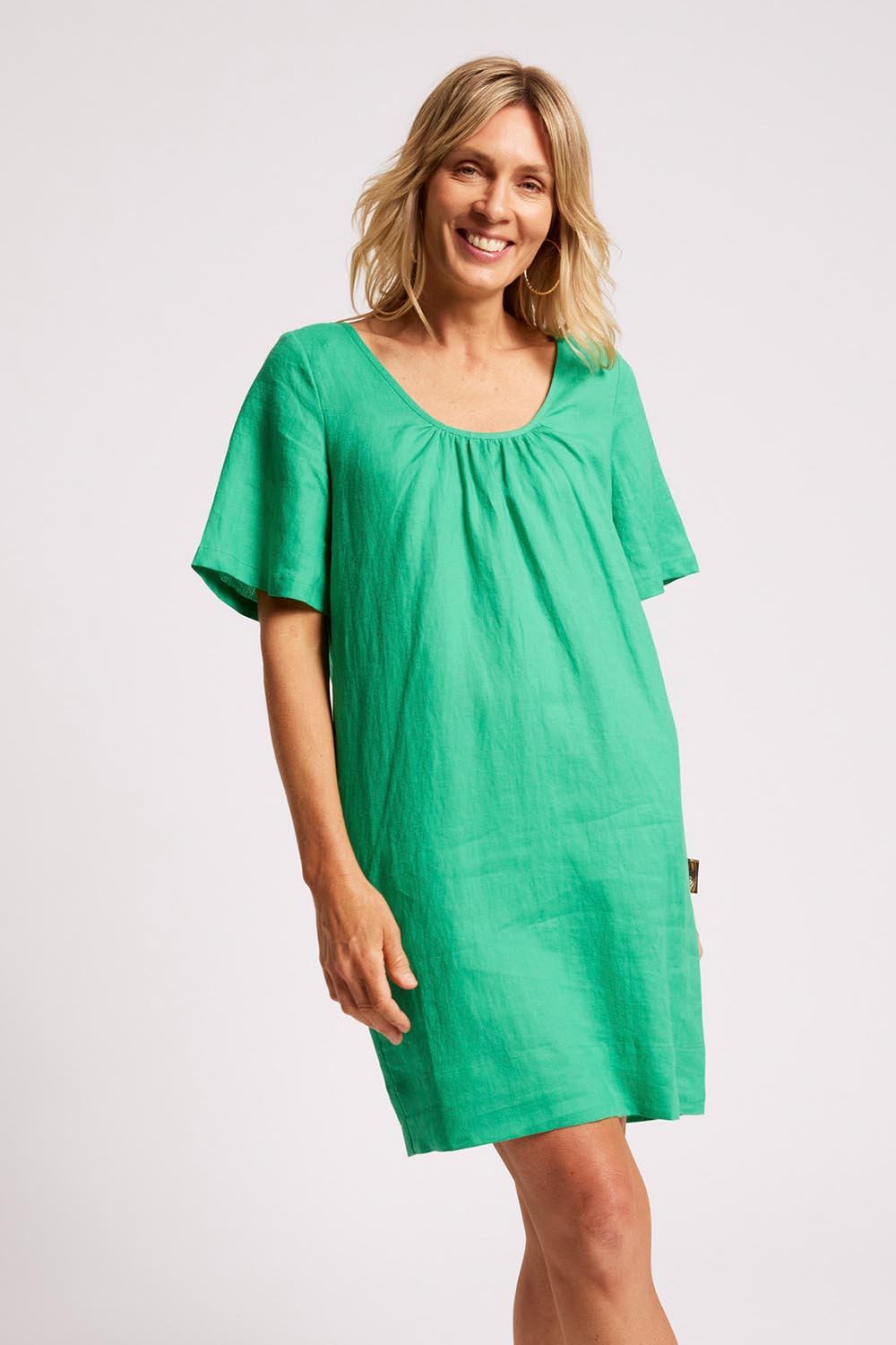Model Genericm wearing size sample of the Cove Dress – Jade in colour Jade, in a cropped view