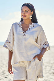 Model Eshan wearing size 10 of the Maris Top – Tusk in colour Tusk, in a cropped view