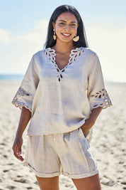 Model Eshan wearing size 10 of the Maris Top – Tusk in colour Tusk, in a cropped view