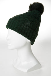 A model wearing the Horizon Beanie in colour Hunter (Green), from the front, showing the whole outfit