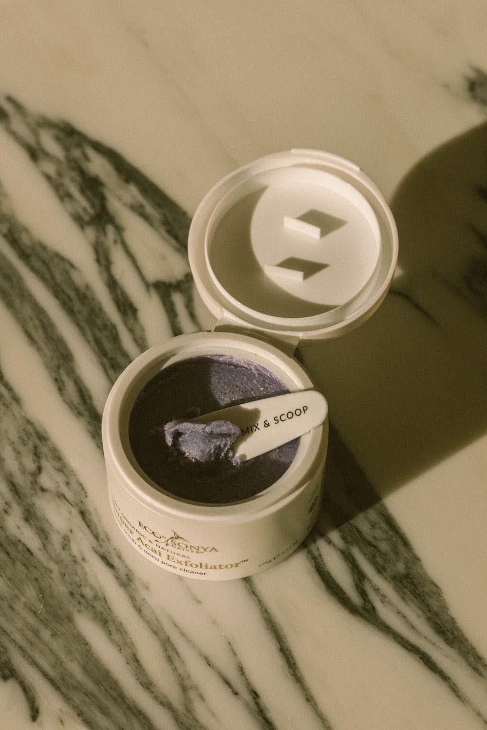 A model wearing the Super Acai Exfoliator in colour Natural, from the front, showing the whole outfit