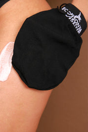 A model wearing the Tan Remover Glove in colour Natural, from the front, showing the whole outfit