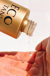 A model wearing the Face Tan Water in colour Tan, from the front, showing the whole outfit