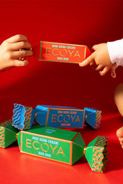 A model wearing the Mini Hand Cream Bon Bon in colour Strawberry (Red), from the front, showing the whole outfit