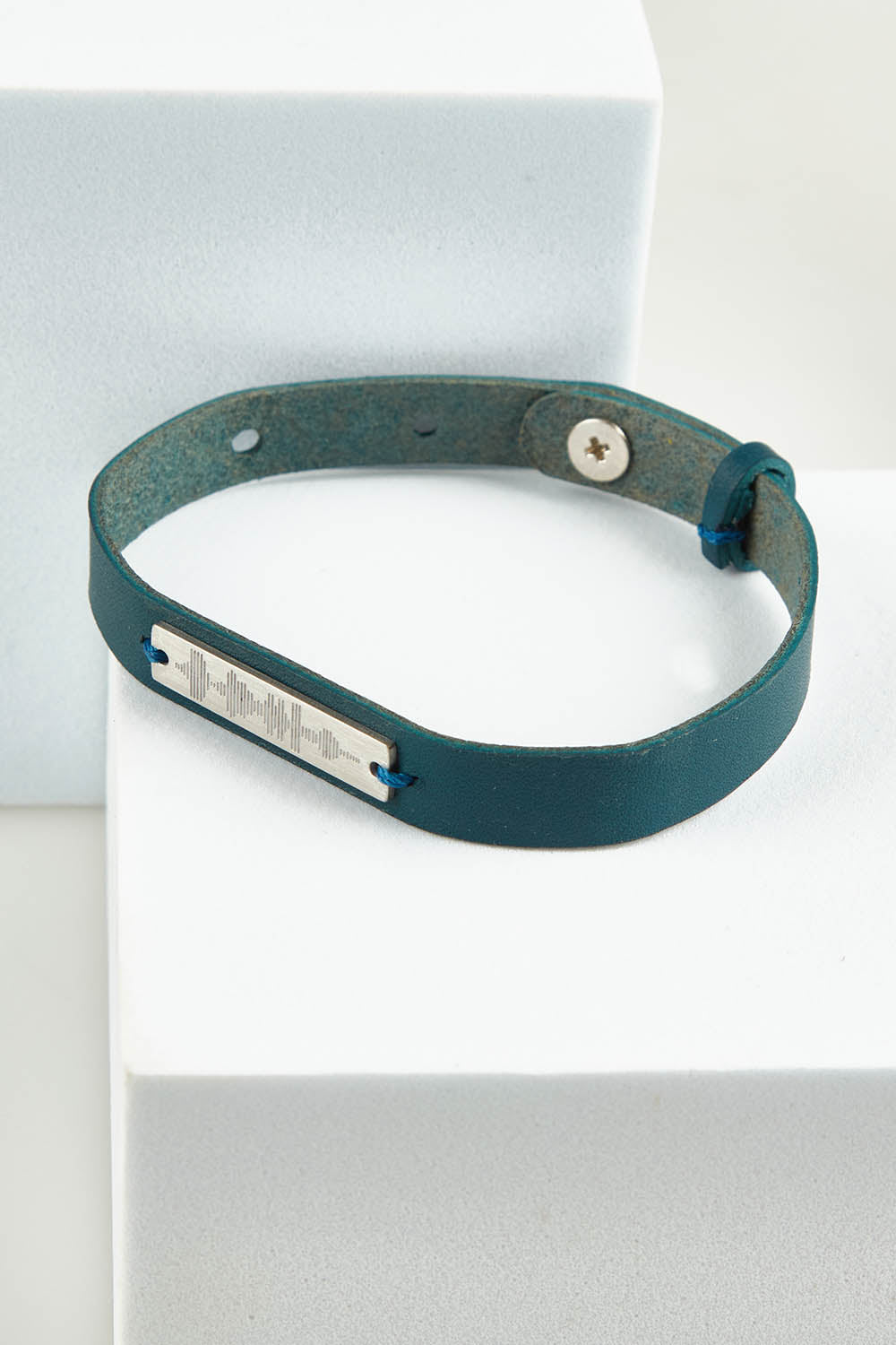 A model wearing the Light Triumphs Over Darkness Thick Vegan Leather Bracelet in colour Blue (Blue), from the front, showing the whole outfit