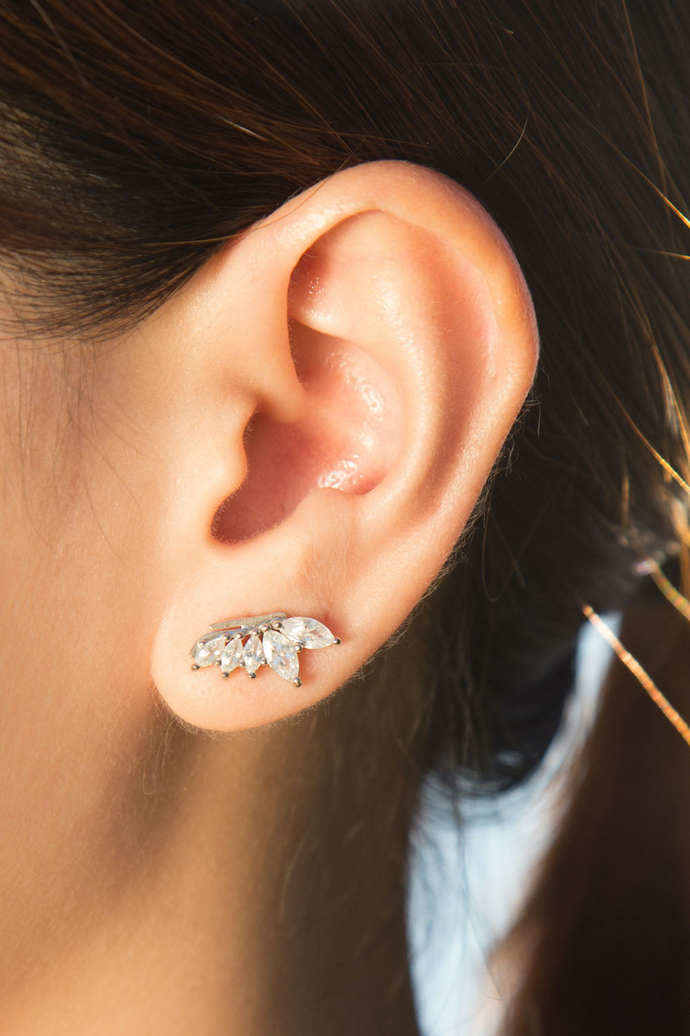 A model wearing the Time To Rise Post Earrings in colour Silver (Metallics), from the front, showing the whole outfit