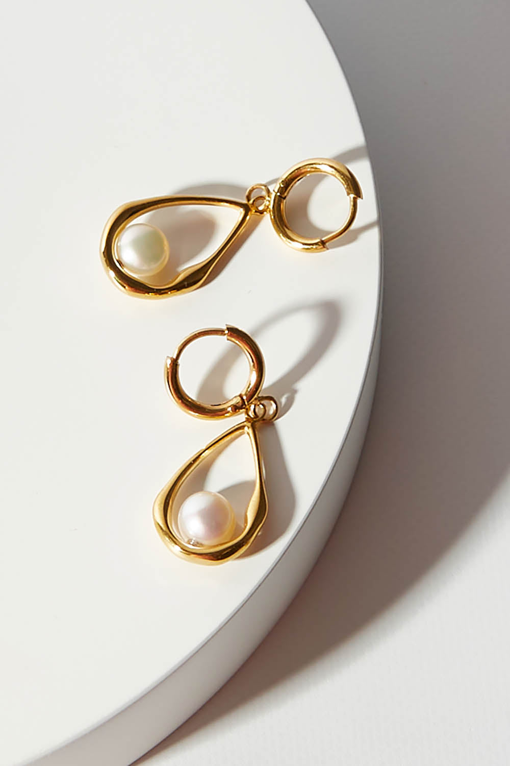 A model wearing size OneSize of the Milk And Honey Drop Earrings in colour Gold (Metallics), from the front, showing the whole outfit