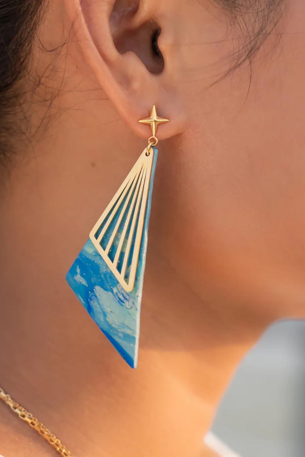 A model wearing the Parting Waters Drop Earring in colour Bluegold (Metallics), from the front, showing the whole outfit