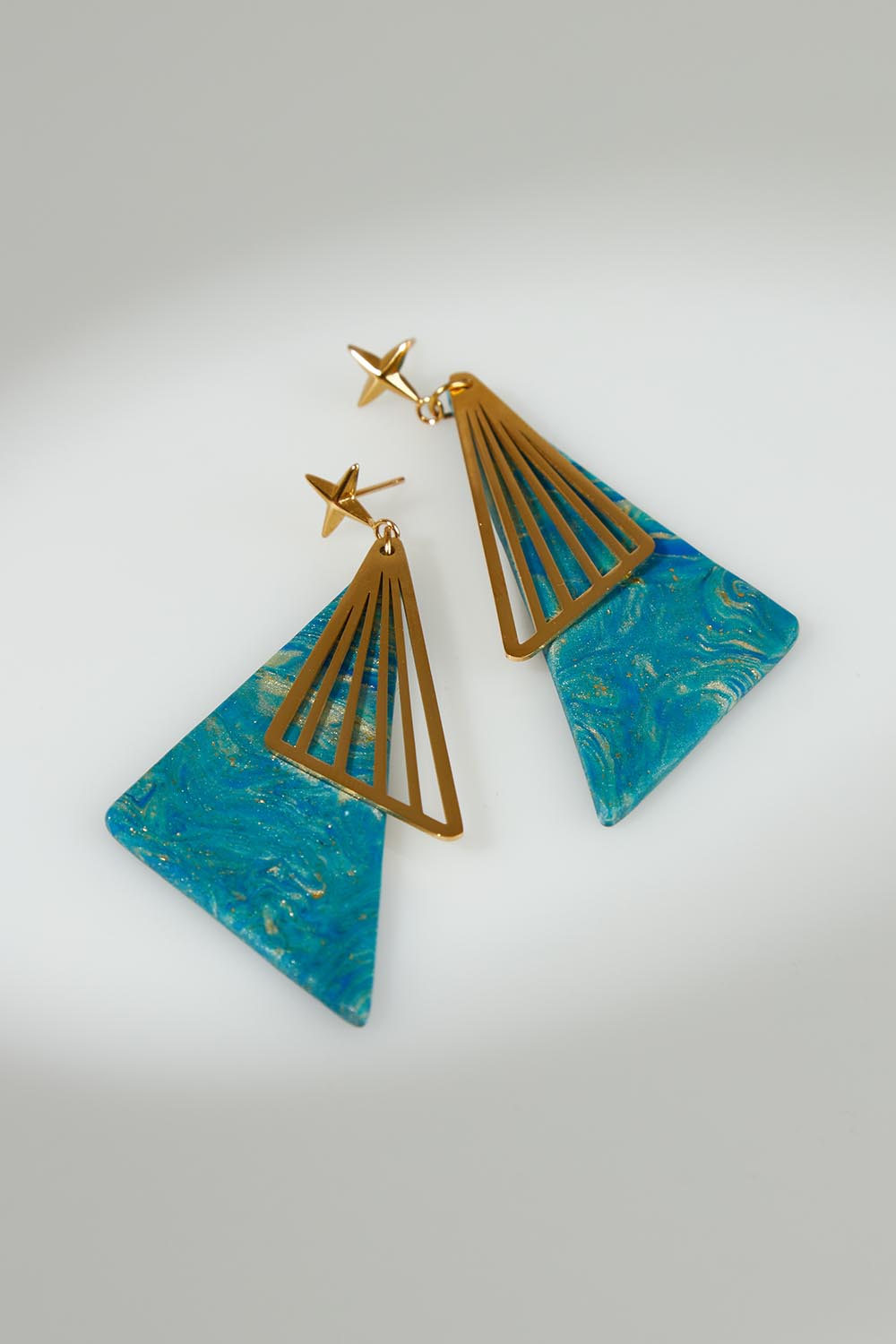 A model wearing the Parting Waters Drop Earring in colour Bluegold (Metallics), from the front, showing the whole outfit