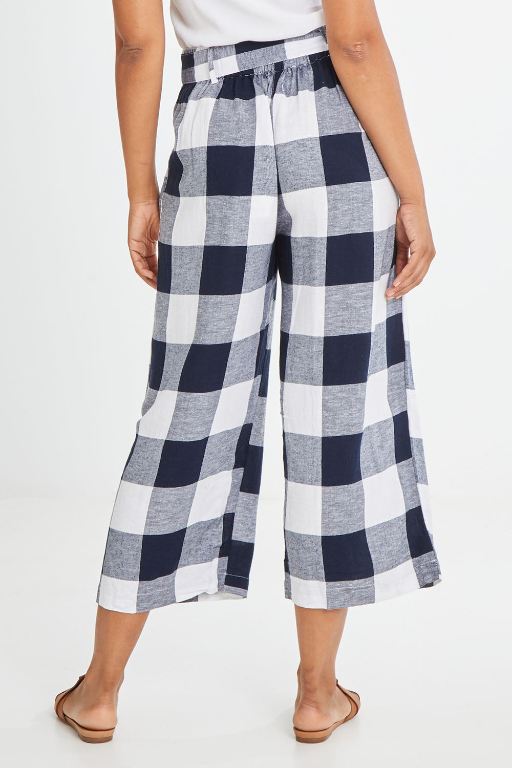 Model Olivia wearing size 10 of the Willow Check Pants in colour Navy (Blue), from the back