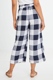 Model Olivia wearing size 10 of the Willow Check Pants in colour Navy (Blue), from the back