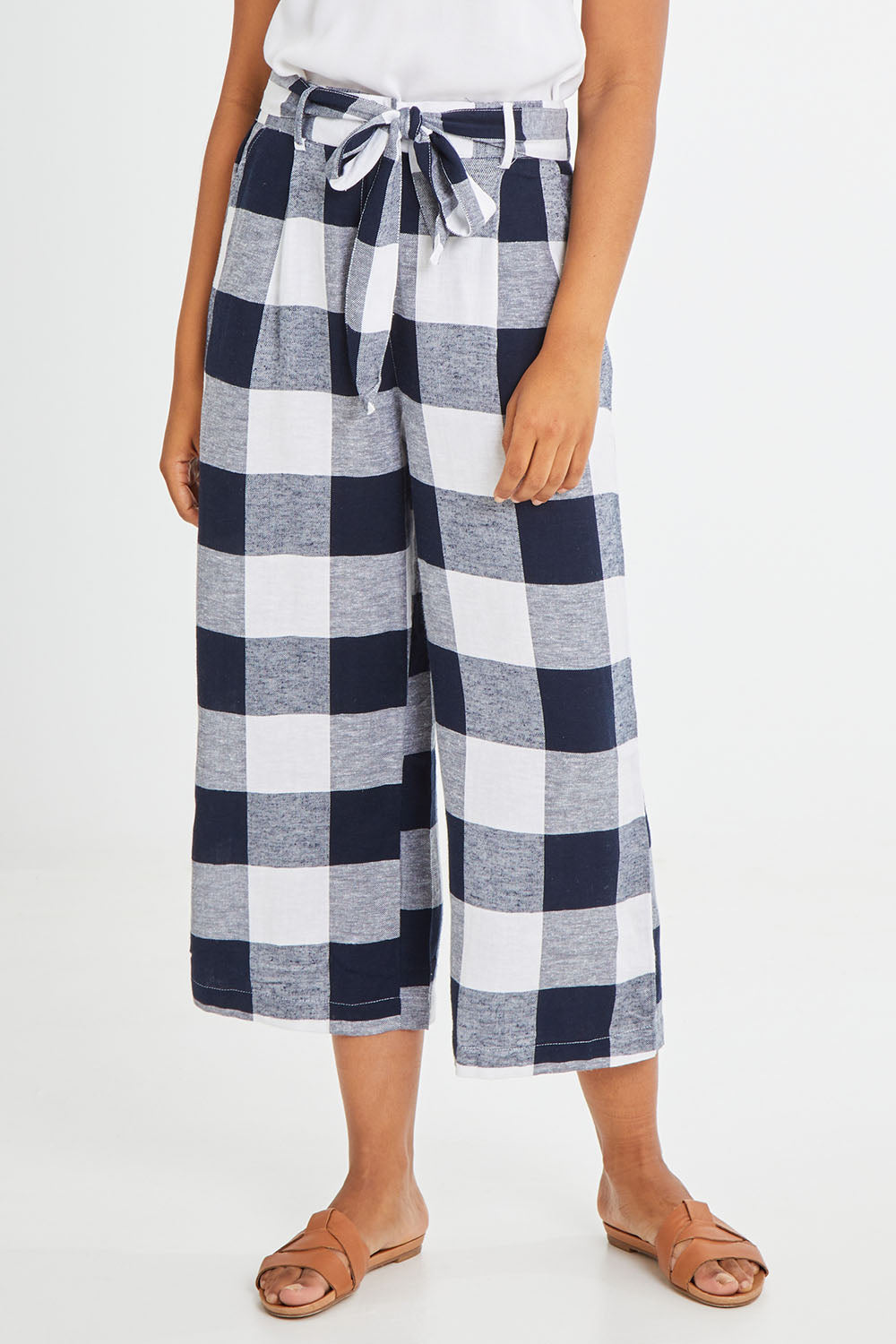 Model Olivia wearing size 10 of the Willow Check Pants in colour Navy (Blue), from the front, cropped image