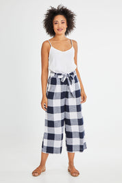 Model Olivia wearing size 10 of the Willow Check Pants in colour Navy (Blue), from the front, showing the whole outfit