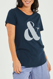 Model Katie wearing size 10 of the Ampersand Tee in colour Drksapp (Blue), from the front, cropped image