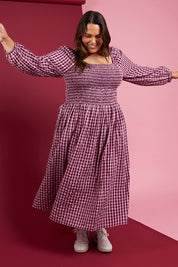 A model wearing the Pippa Check Dress in colour Winecheck (Purple), from the front, showing the whole outfit