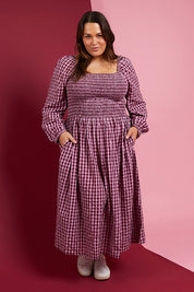 A model wearing the Pippa Check Dress in colour Winecheck (Purple), from the front, showing the whole outfit