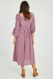 Model Madeline wearing size 10 of the Pippa Check Dress in colour Winecheck (Purple), from the back