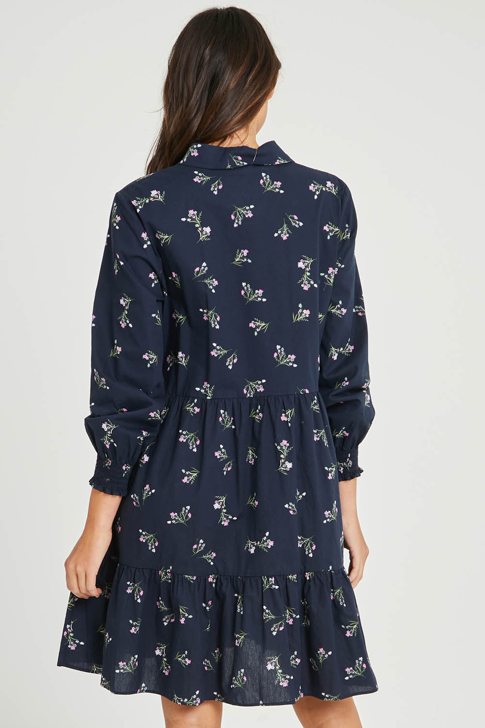 Model Madeline wearing size 10 of the Jolie Floral Shirt Dress in colour Navyfloral (Blue), from the back