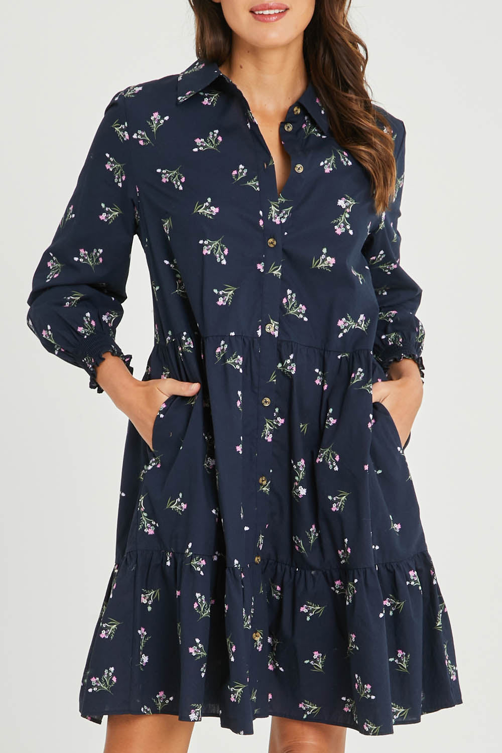 Model Madeline wearing size 10 of the Jolie Floral Shirt Dress in colour Navyfloral (Blue), from the front, cropped image