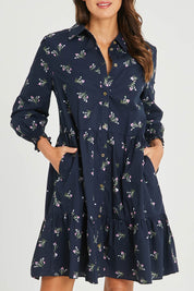 Model Madeline wearing size 10 of the Jolie Floral Shirt Dress in colour Navyfloral (Blue), from the front, cropped image