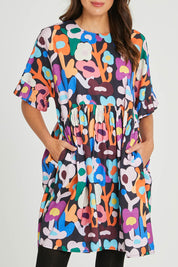 Model Madeline wearing size 10 of the Xander Dress in colour Floral (Blue), from the front, cropped image