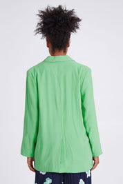 Model Olivia wearing size 10 of the Rhiannon Blazer in colour Meadow (Green), from the back