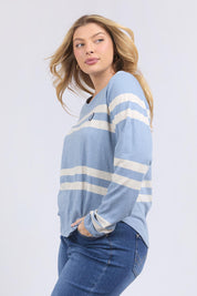 A model wearing the Allegra Long Sleeve Cotton Tee in colour Marshblue (White), from the front, cropped image