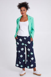 Model Olivia wearing size 10 of the Juno Floral Pant in colour Navyjuno (Blue), from the front, showing the whole outfit