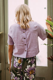 A model wearing the Juniper Top in colour Periwinkle (Purple), from the front, showing the whole outfit