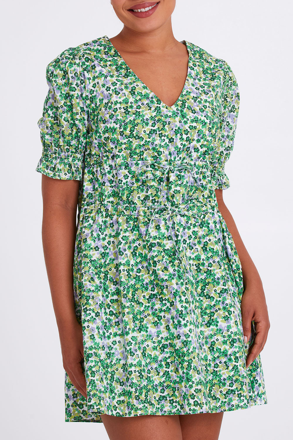 Model Olivia wearing size 10 of the Prairie Floral Dress in colour Prairie (Green), from the front, cropped image