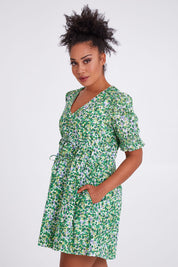 Model Olivia wearing size 10 of the Prairie Floral Dress in colour Prairie (Green), from the front, cropped image