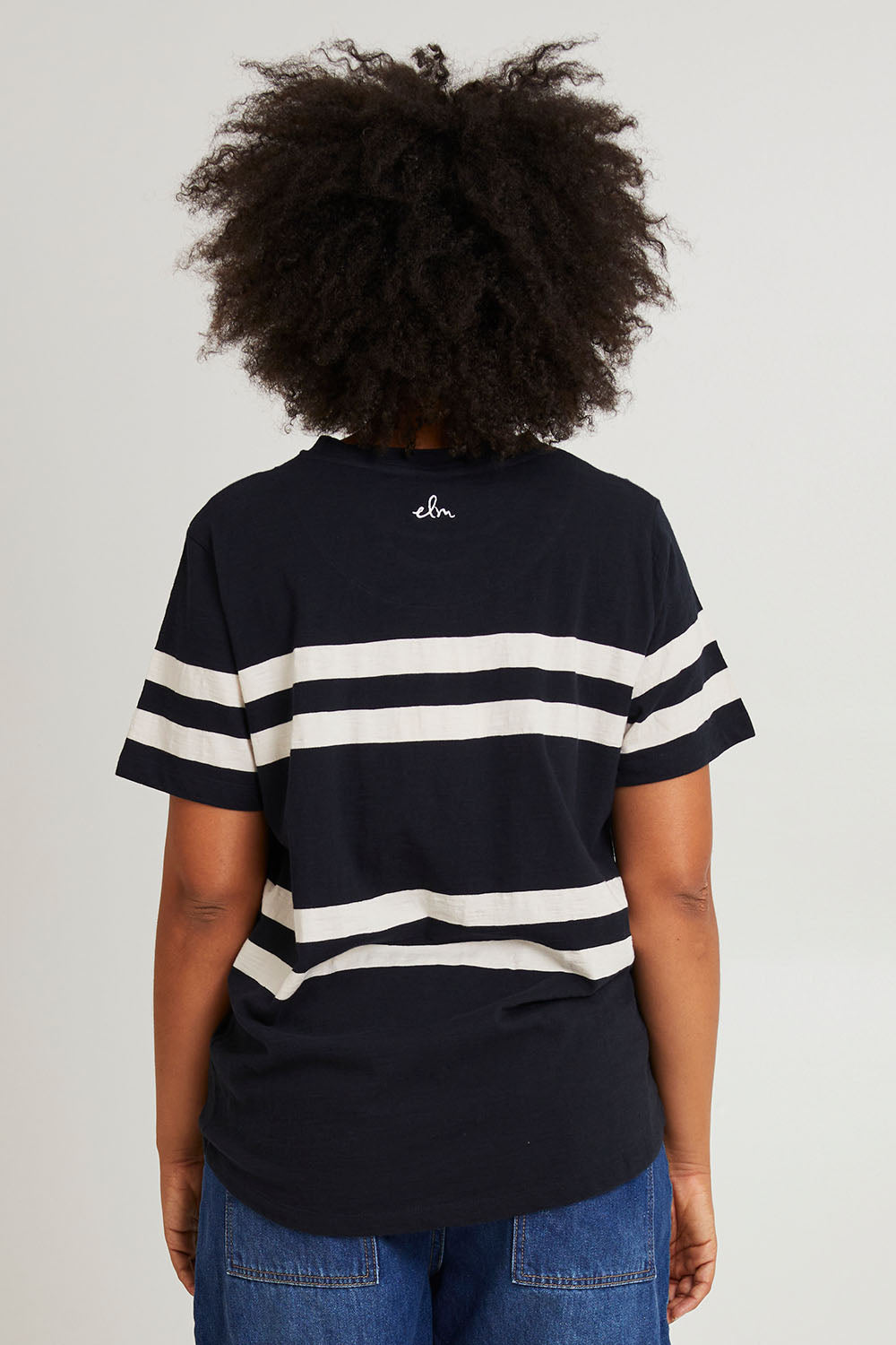 Model Olivia wearing size 10 of the Allegra Ss Tee in colour Navywhite (Blue), from the back