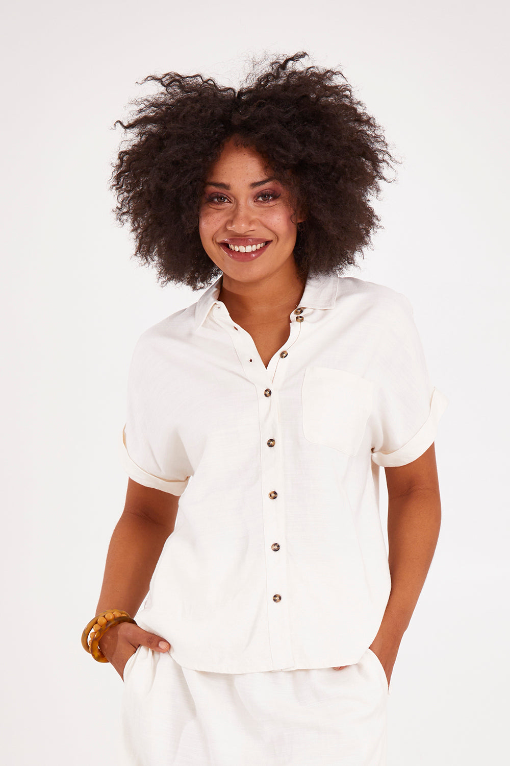 Model Olivia wearing size 10 of the Clem Shirt in colour Coconut (White), from the front, cropped image