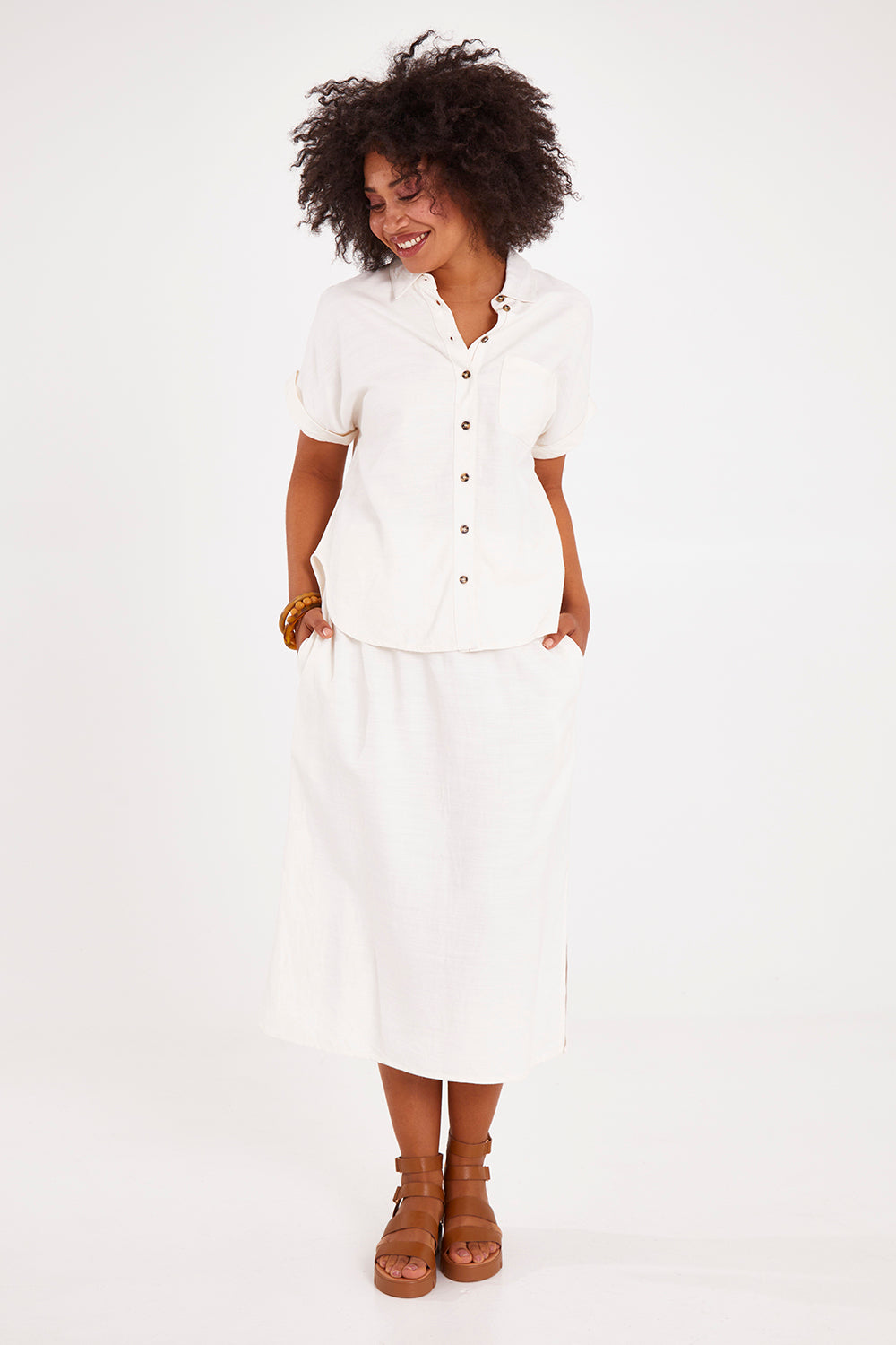 Model Olivia wearing size 10 of the Clem Shirt in colour Coconut (White), from the front, showing the whole outfit