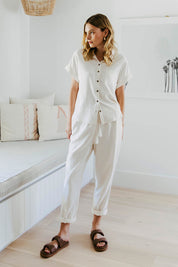A model wearing the Clem Relaxed Linen Blend Pant in colour Coconut (White), from the front, showing the whole outfit