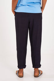 Model Olivia wearing size 10 of the Clem Relaxed Linen Blend Pant in colour Dksapphire (Blue), from the back