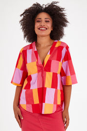 Model Olivia wearing size 10 of the Soleil Check Top in colour Solcheck, from the front, cropped image