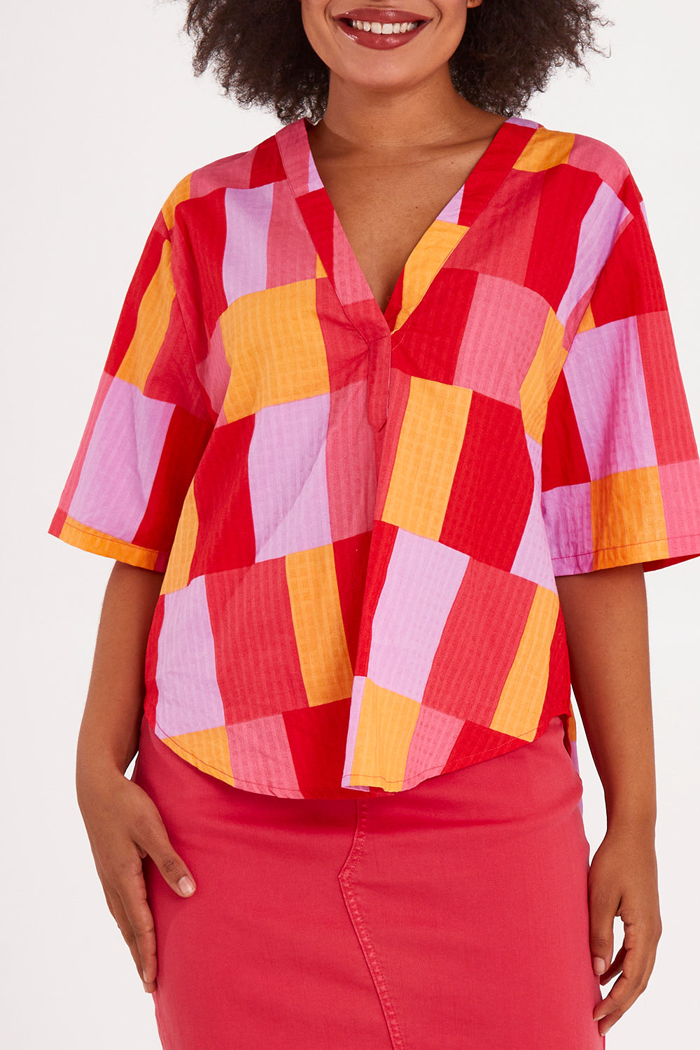 Model Olivia wearing size 10 of the Soleil Check Top in colour Solcheck, from the front, cropped image