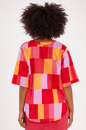 Model Olivia wearing size 10 of the Soleil Check Top in colour Solcheck, from the front, cropped image