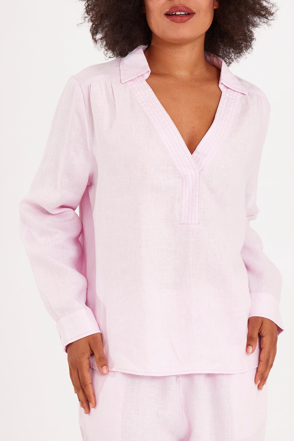 Model Olivia wearing size 10 of the Blair Open Neck Shirt in colour Blossom (Pink), from the front, cropped image