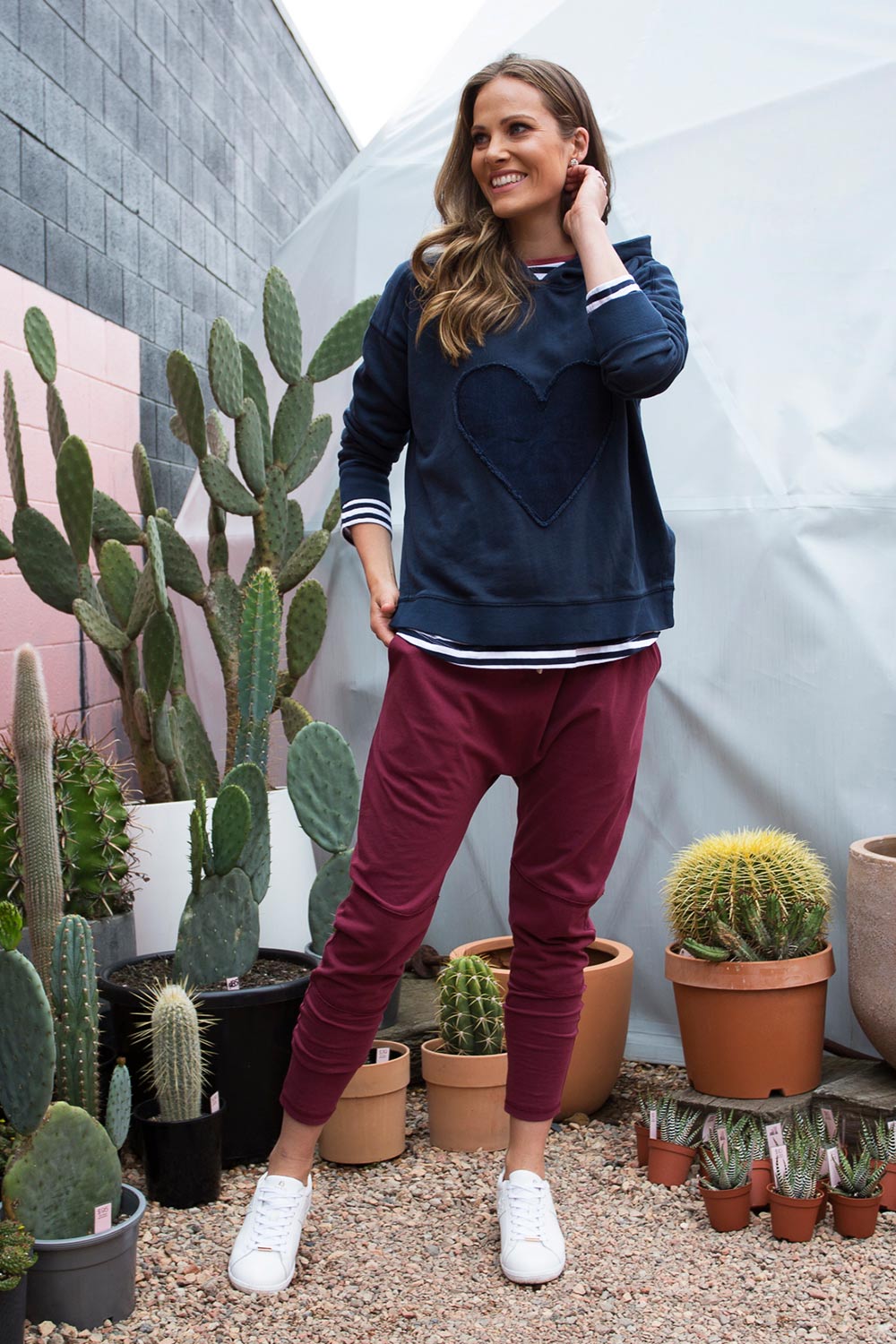 A model wearing the Weekend Picnic Pant in colour Burgandy (Purple), from the front, showing the whole outfit