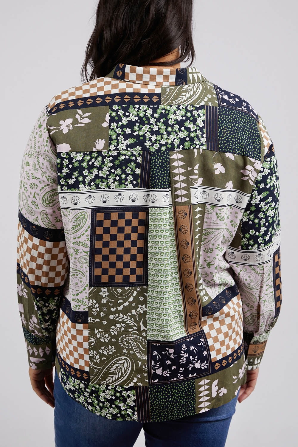 A model wearing the Vetiver Patchwork Shirt in colour Patchwork (Green), from the back