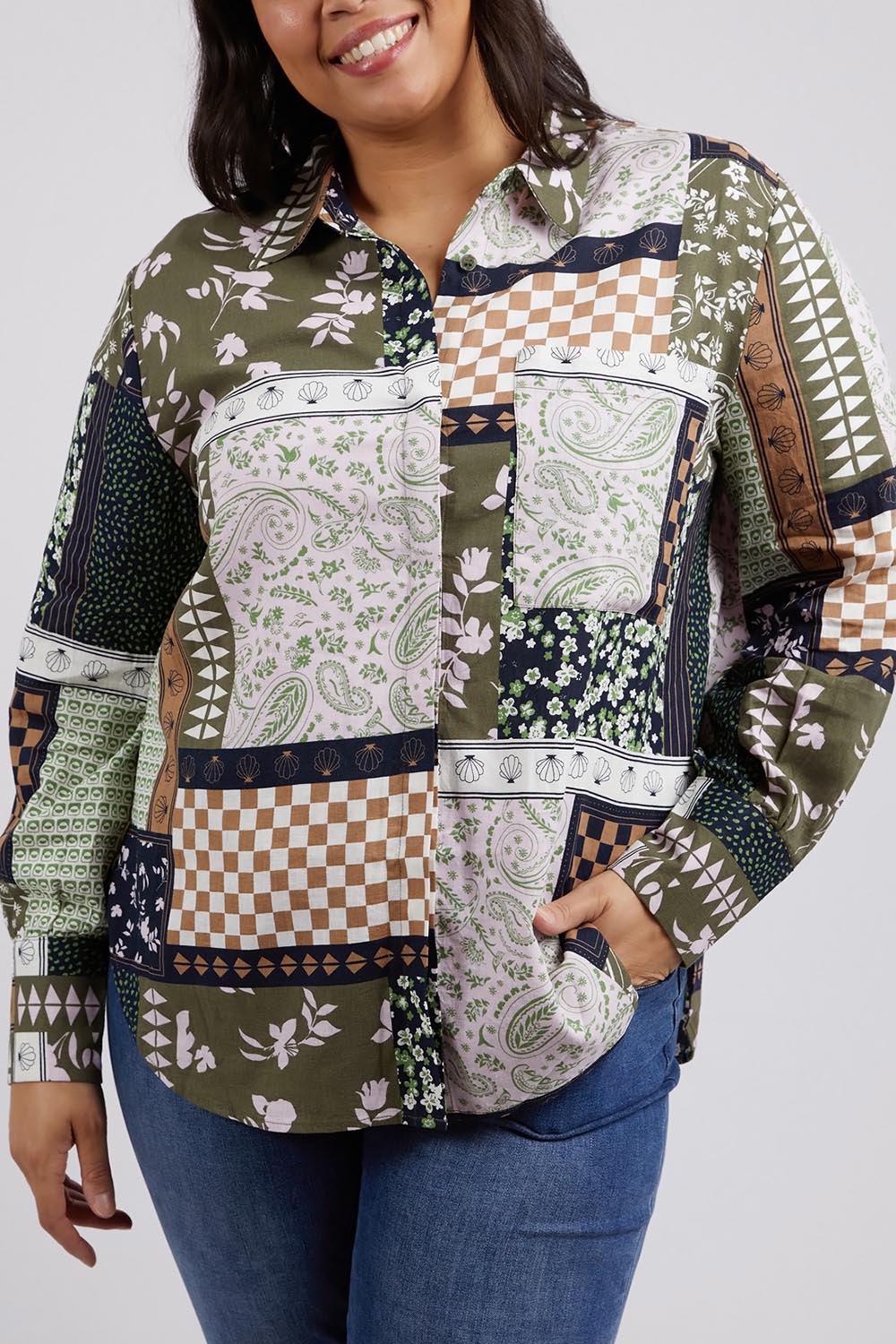 A model wearing the Vetiver Patchwork Shirt in colour Patchwork (Green), from the front, cropped image