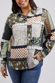 A model wearing the Vetiver Patchwork Shirt in colour Patchwork (Green), from the front, cropped image