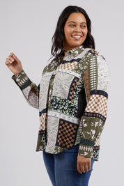 A model wearing the Vetiver Patchwork Shirt in colour Patchwork (Green), from the front, cropped image