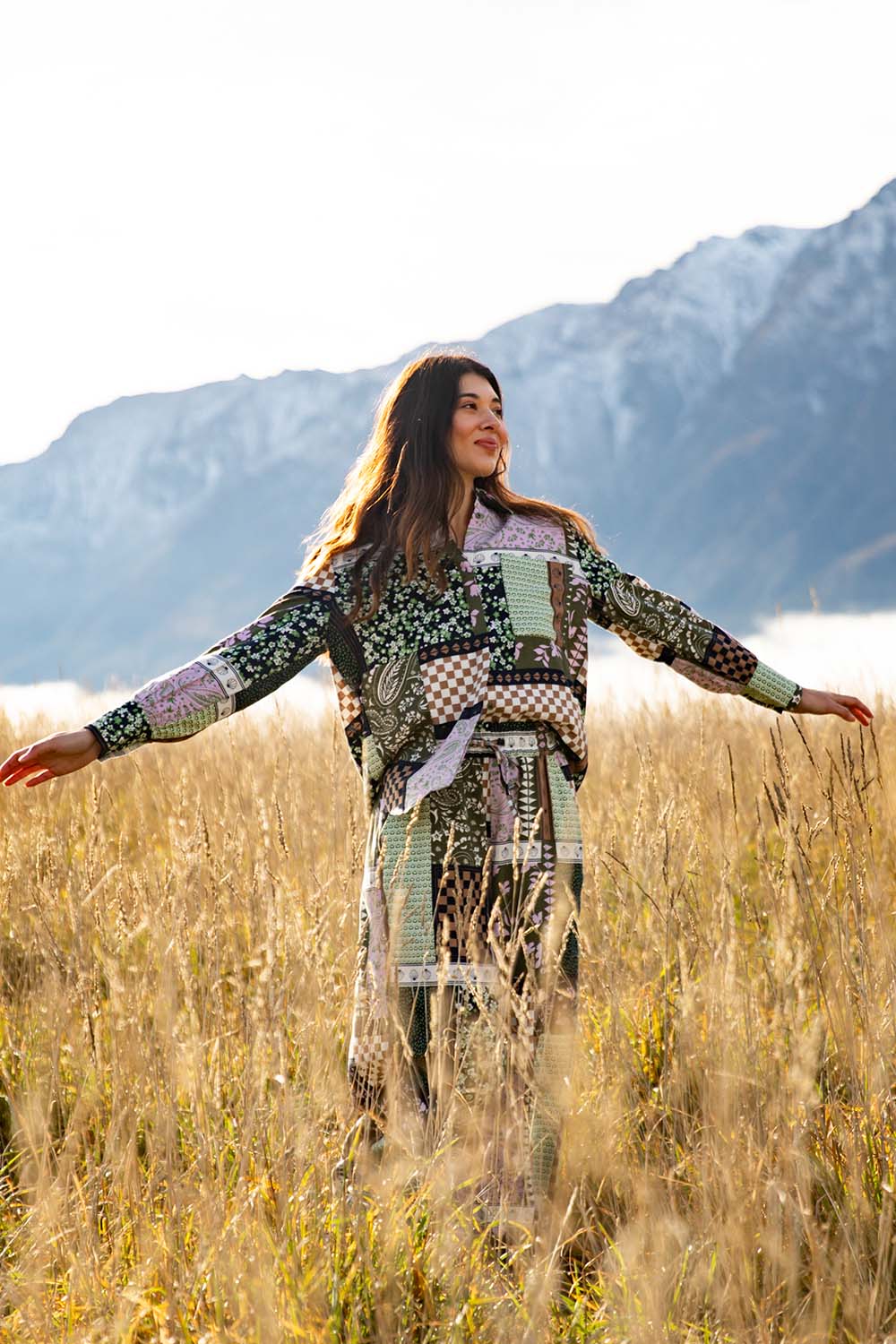 A model wearing the Vetiver Patchwork Shirt in colour Patchwork (Green), from the front, showing the whole outfit