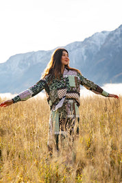 A model wearing the Vetiver Patchwork Shirt in colour Patchwork (Green), from the front, showing the whole outfit